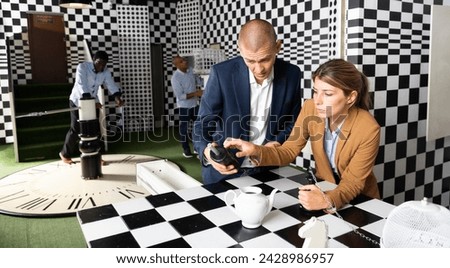 Adults people trying together to find solution of conundrum in quest room
