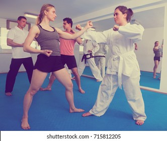 Adults Are Practicing New Karate Moves In Pairs In Class. 