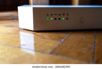 Advance White Wifi Router, Asymmetric Digital Subscriber Line Modem With Lights Blinking Showing Internet Data Activation.