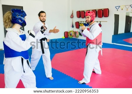 Advanced adults sparring during a taekwondo martial arts competition