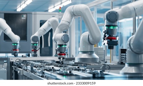 Advanced High Precision Robot Arm inside Bright Electronics Factory. Electronic Devices Production Industry. Component Installation on Circuit Board. Fully Automated Modern PCB Assembly Line. - Shutterstock ID 2333009159