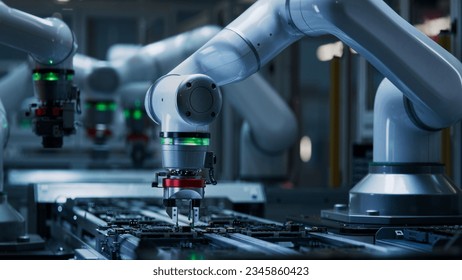 Advanced High Precision Robot Arm inside Electronics Factory. Component Installation on Black Circuit Board. Electronic Devices Production Industry. Fully Automated Modern PCB Assembly Line.