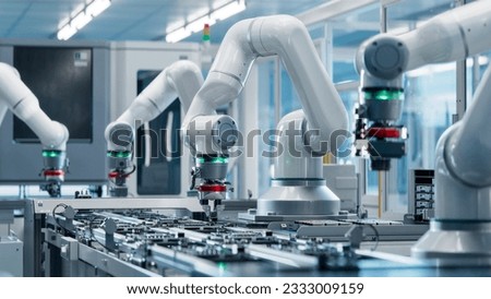 Advanced High Precision Robot Arm inside Bright Electronics Factory. Electronic Devices Production Industry. Component Installation on Circuit Board. Fully Automated Modern PCB Assembly Line.