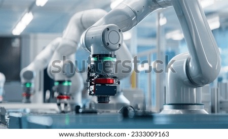 Advanced High Precision Robot Arm inside Bright Electronics Factory. Electronic Devices Production Industry. Fully Automated Modern PCB Assembly Line. Quality Control of Circuit Board