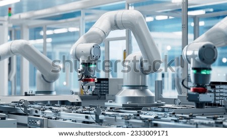 Advanced High Precision Robot Arm inside Bright Electronics Factory. Component Installation on Circuit Board. Electronic Devices Production Industry. Fully Automated Modern PCB Assembly Line.