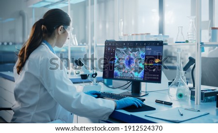 Advanced Medical Science Laboratory: Medical Scientist Working on Personal Computer with Screen Showing Virus Analysis Software User Interface. Scientists Developing Vaccine, Drugs and Antibiotics.