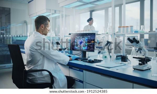 Advanced Medical Science Laboratory: Medical\
Scientist Working on Personal Computer with Screen Showing Virus\
Analysis Software User Interface. Scientists Developing Vaccine,\
Drugs and Antibiotics.