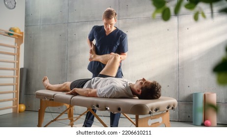 Advanced Sport Physiotherapy Specialist Stretching and Working on Specific Muscle Groups or Joints with Young Male Athlete. Fit Sportsman Recovering from Mild Injury, Undergoing Rehabilitation. - Powered by Shutterstock