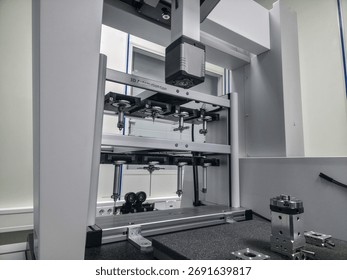 Advanced testing machine is set up in a laboratory to evaluate material strength. The equipment features multiple grips and sensors, ensuring accurate measurements for quality control.