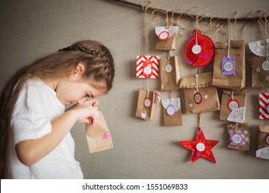 Advent Calendar Hanging On The Wall. Child Opens Present. Christmas Kids Fun. Diy.