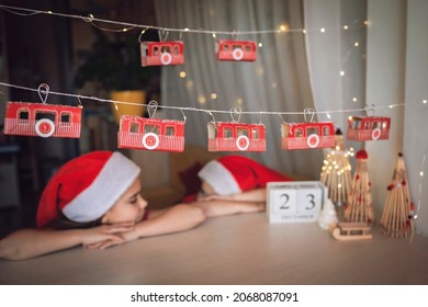 Advent Calendar Like Ski Lift On Mountain Resort. Kids Look At Funicular Cabin With Toilette Paper Roll. Zero Waste And Reusable Christmas. Magic Winter Holiday, Blurred Lights, Focus On Cable Car