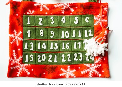 Advent Calendar with Santa Claus made of red, green and white felt fabric for counting down to Christmas, white background - Powered by Shutterstock