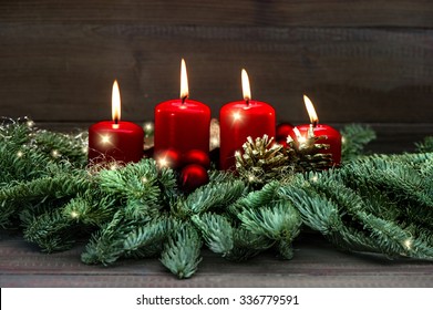 Advent decoration wreath with four red burning candles and light effects. Holidays background. selective focus