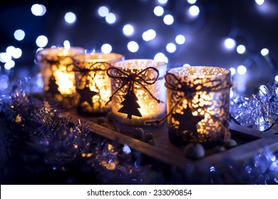 Advent, Four Candles Decorated Christmas Tree On A Background Of Lights