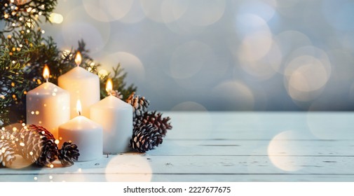 Advent white candles with decor in shiny lights closeup - Powered by Shutterstock