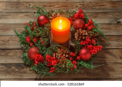 Advent wreath with candle on wooden table. Christmas time.
