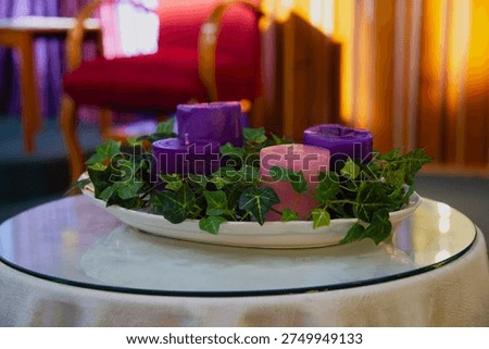 Advent wreath decorating a table with three purple candles and one pink candle, symbolizing the christian hope and anticipation of christmas
