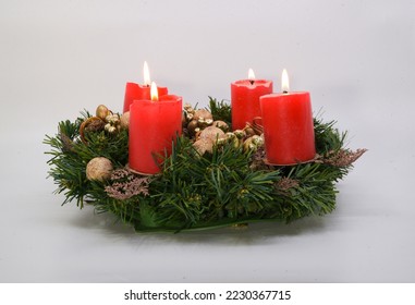advent wreath with four lit candles on the fourth advent