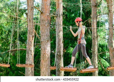 Adventure Climbing High Wire Park - Young Woman On Course In Mountain Helmet And Safety Equipment