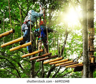 Adventure Climbing High Wire Park - People On Course In Mountain Helmet And Safety Equipment