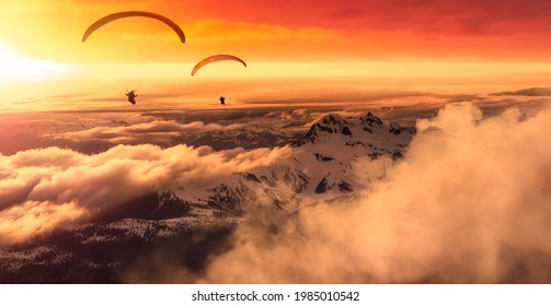 Adventure Composite Image of Paraglider Flying up high in the Rocky Mountains. Sunny Sunset Sky. Aerial Background from British Columbia, Canada. Extreme Sport Concept. Panorama