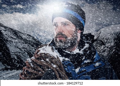 Adventure Mountain Man In Snow Expedition With Climbing Gear And Determination