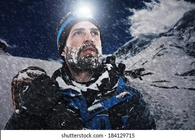 Adventure Mountain Man In Snow Expedition With Climbing Gear And Determination