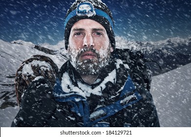 Adventure Mountain Man In Snow Expedition With Climbing Gear And Determination