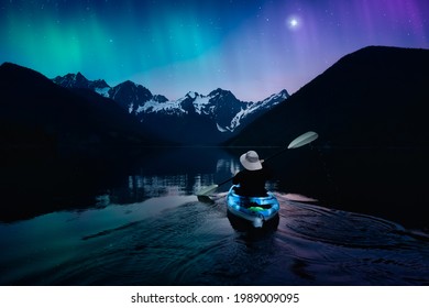 Adventure Person Kayaking in a Peaceful Lake at Night. Colorful Sky with Starts and Aurora Art Render. Canadian Landscape from British Columbia, Canada. - Powered by Shutterstock