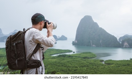 Adventure photographer taking landscape photos. Phang Nga Bay, Samet Nangshe Viewpoint, Thailand