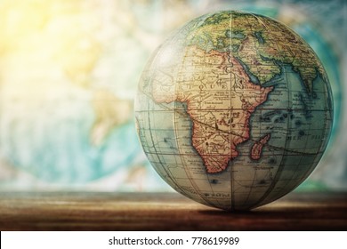 Adventure Stories Education Background. Old Globe On Map Background. Selective Focus.