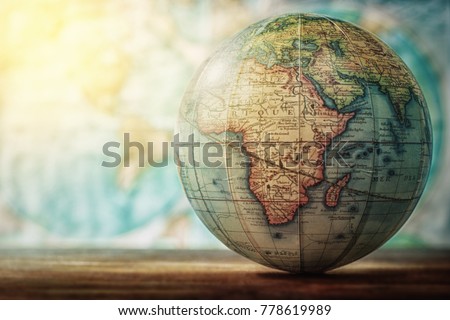 Adventure stories education background. Old globe on map background. Selective focus.