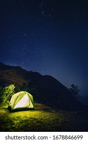 adventure travel from colourful of camping tent  on the mountain with soft focus star background in summer season