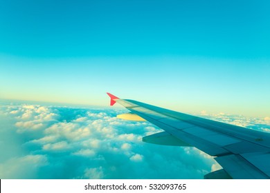 Adventure, Travel, Transport Concept. View From Plane Window At Sky With Clouds And Wing