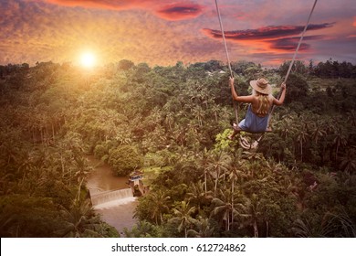 Adventure In Wild Jungle Forest. Woman On Swing.