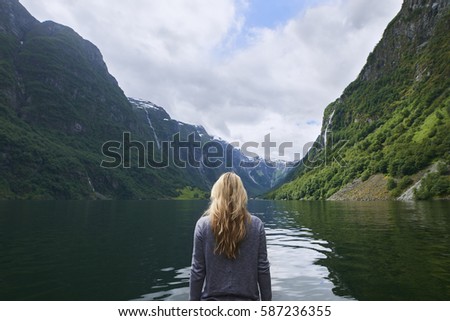Adventure woman enjoying view of majestic mountain lake explore travel discover beautiful earth