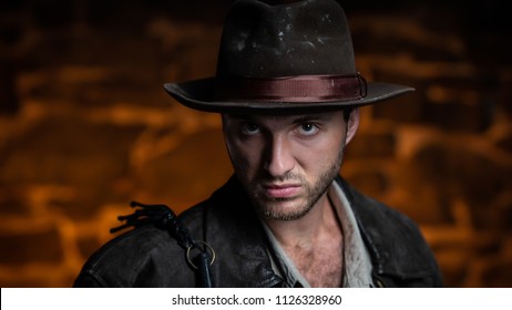 Adventurer (Indiana Jones). Stone Wall Background.