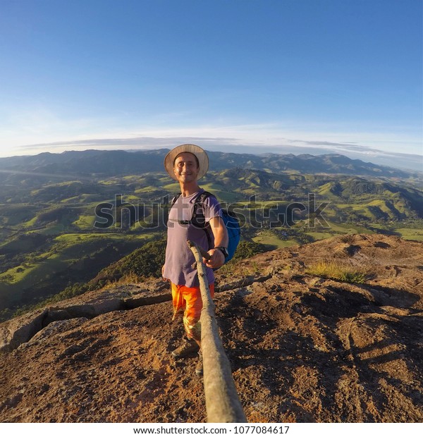 Adventurer man on mountain top, adventure\
freedom concept.