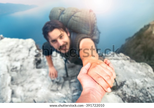 adventurers\
helping each other to climb the\
mountain