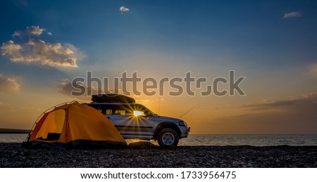 Adventures Camping tourism and tent and car next to the lake. Landscape outdoor in morning