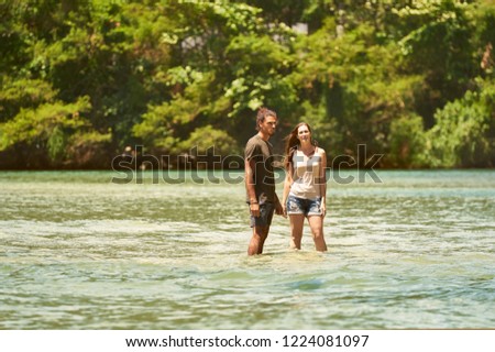 Adventurous Authentic Couple Hiking in an Unique Island Scenery With Teal Water, Sunny Warm Look and Atlantic Forest Background