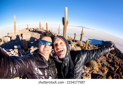 Adventurous Best Friends Taking Selfie At Salar De Uyuni In Bolivia - Travel Life Style Enjoying Happy Fun Moment - Trip Together Around World Wonders - Bright Filter With Fisheye Horizon Distortion