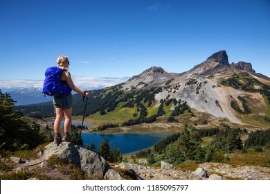 Adventurous girl enjoying the beautiful Canadian Mountain Landscape during a vibrant summer day. Taken in Garibaldi Provincial Park, located near Whister and Squamish, North of Vancouver, BC, Canada.