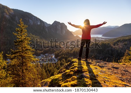 Adventurous Girl Hiking in the mountains during a sunny Autumn Sunset. Taken Squamish, North of Vancouver, British Columbia, Canada. Concept: Adventure, freedom, lifestyle