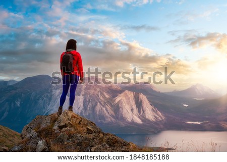Adventurous Girl Hiking up the Nares Mountain. Dramatic Colorful Sunrise Sky Art Render. Taken near Whitehorse, Yukon, Canada.