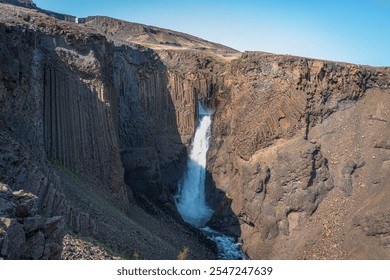 An adventurous hike through East Iceland leads to the stunning Hengifoss and Litlanesfoss waterfalls, surrounded by striking basalt columns and rugged landscapes - Powered by Shutterstock