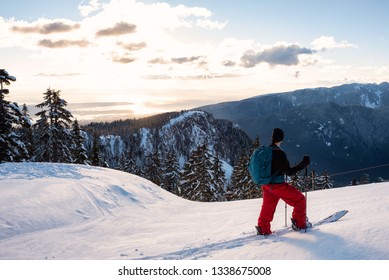 Adventurous Man Is Backcountry Skiing Up Mount Seymour During A Sunny Winter Sunset. Taken In North Vancouver, BC, Canada.