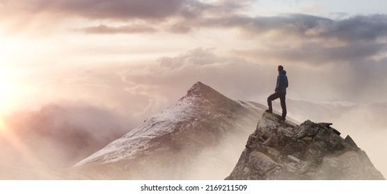 Adventurous Man Hiker standing on top of icy peak with rocky mountains. Adventure Composite. Aerial Background Image of landscape from Yukon, Canada. Sunset Sky