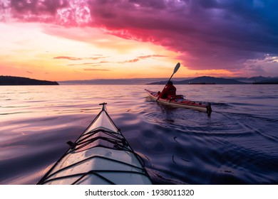 Adventurous Man Sea Kayaking in the Pacific Ocean. Dramatic Colorful Sky Art Render. Taken in Jericho, Vancouver, British Columbia, Canada. - Shutterstock ID 1938011320