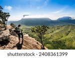 adventurous woman with backpack looking at a beautiful green valley,vale do paty, chapada diamantina, Brazil